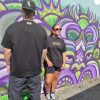 male model showing back and female model using not bad clothing oversized tee orange