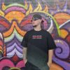 male model using not bad clothing Oversized TEE red, colour graffiti wall